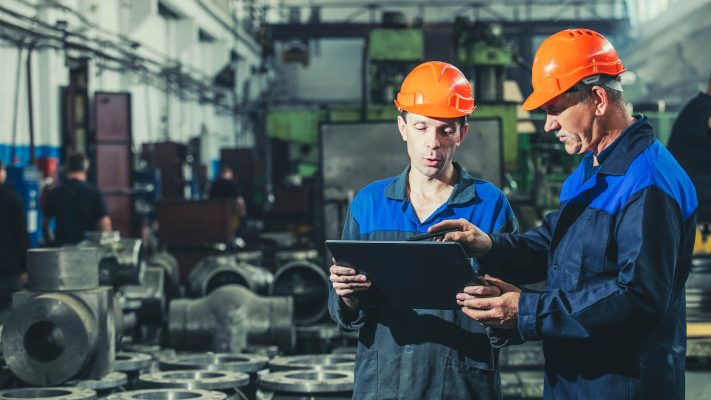 Two-workers-at-an-industrial-plant-with-a-tablet-in-hand-working-together-manufacturing-activities Two-workers-at-an-industrial-plant-with-a-tablet-in-hand-working-together-manufacturing-activities